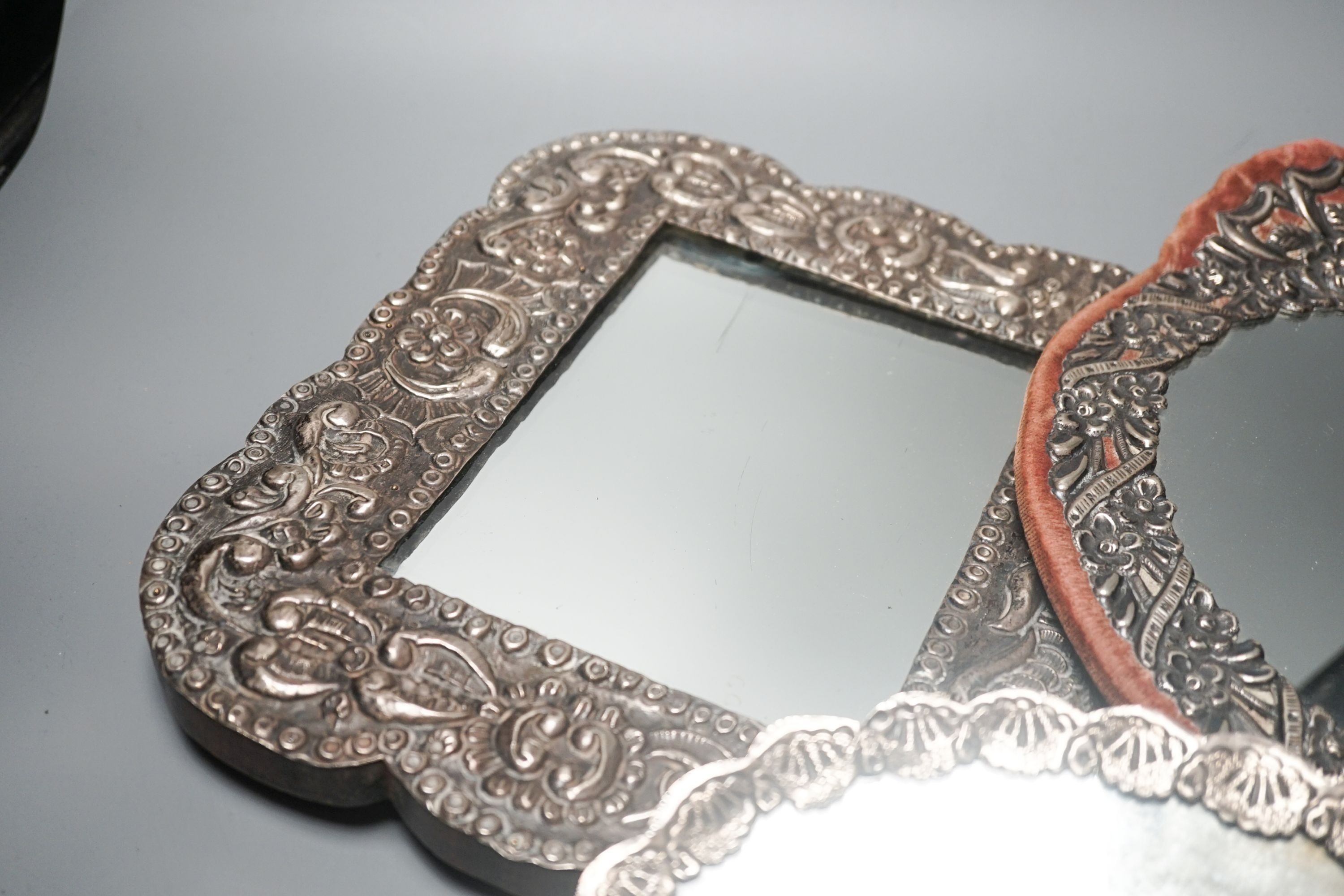 Three assorted Turkish white metal mounted mirrors, largest, 32.2cm.